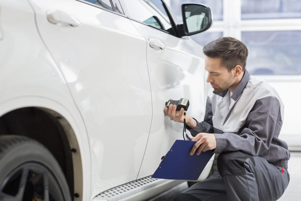 technician scanning white car